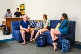 Students hang out on couches in University Hall common space.