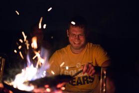 Student stokes campfire