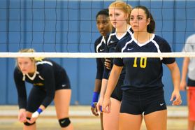 Volleyball players prepare to receive serve