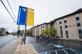 WVU Tech flags hanging from poles in front of Hogan Hall